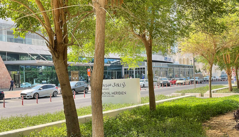 photo of Al Falea street in Dubai near to Royal Oceanic Tower and Botanica Tower, with green trees and cars